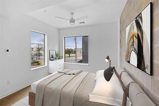 a bedroom with a bed and a large window