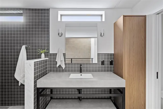 a bathroom with a sink a mirror and shower