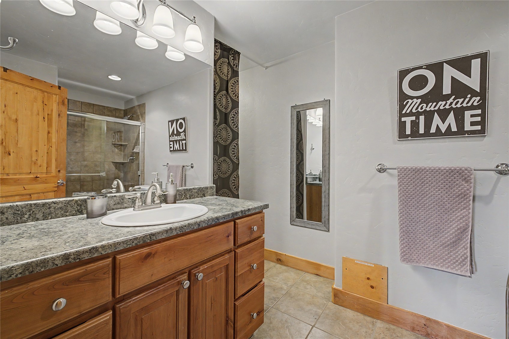 6726 Ryan Gulch Road, Unit 6726 Wildernest, CO 80498 - Photo 19 of 39 a spacious bathroom with a granite countertop sink and a mirror