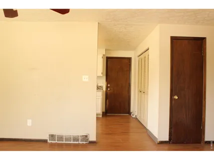 a view of hallway with wooden floor