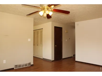 a picture of a room with a ceiling fan