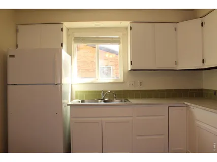 a kitchen with a sink and a refrigerator