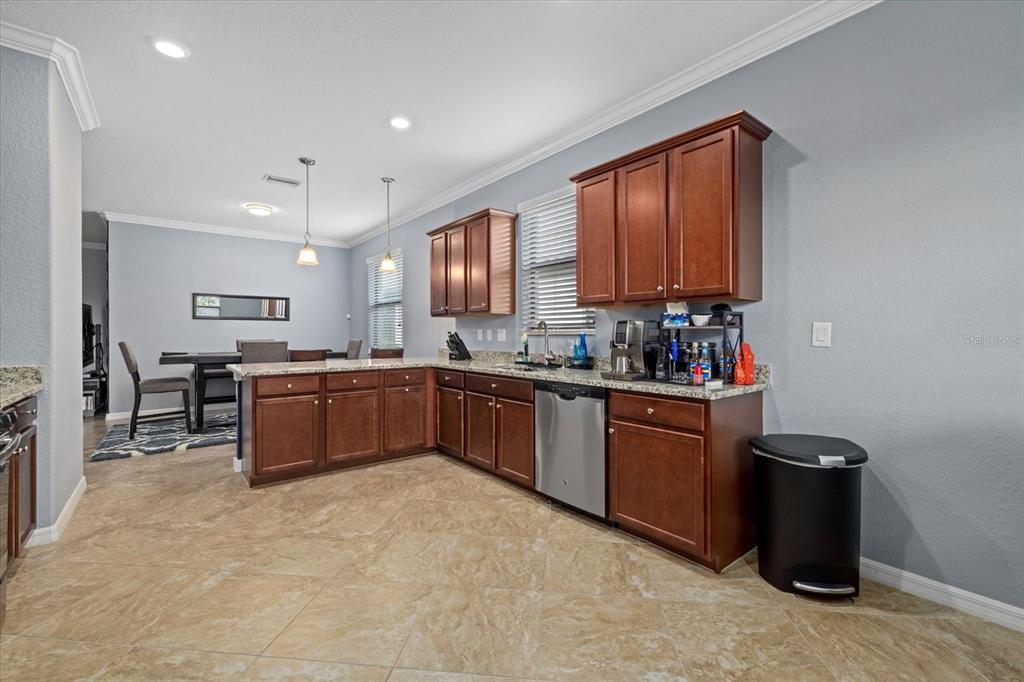 17018 Blue Rdg Place Bradenton, FL 34211 - Photo 13 of 34 a kitchen with a refrigerator sink and wooden cabinets