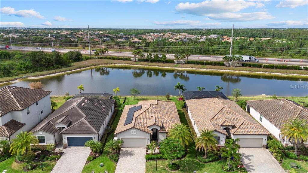 17018 Blue Rdg Place Bradenton, FL 34211 - Photo 2 of 34 an aerial view of a house with a garden and lake view