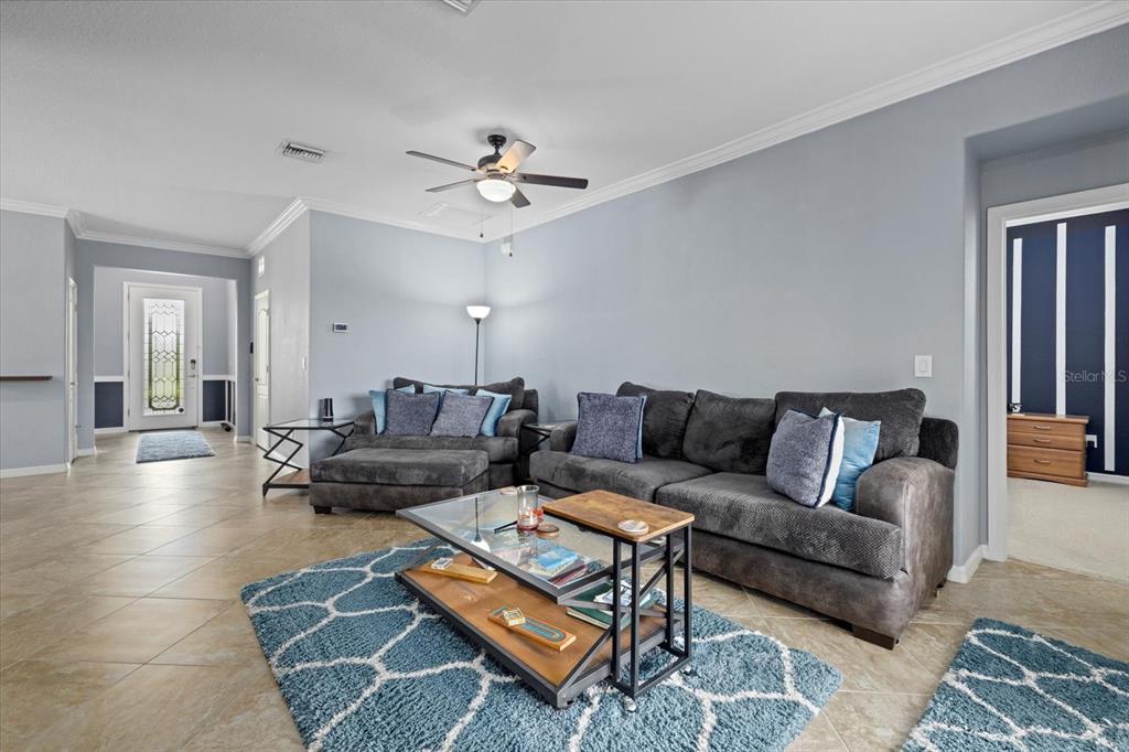 17018 Blue Rdg Place Bradenton, FL 34211 - Photo 8 of 34 a living room with furniture a rug and a chandelier
