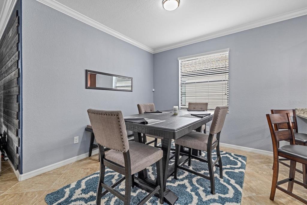 17018 Blue Rdg Place Bradenton, FL 34211 - Photo 10 of 34 a view of a dining room with furniture and wooden floor