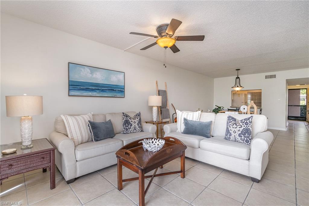 5535 Rattlesnake Hammock Road, Unit 103 Naples, FL 34113 - Photo 1 of 25 Natural light filled family room, styled with neutral coastal decor.