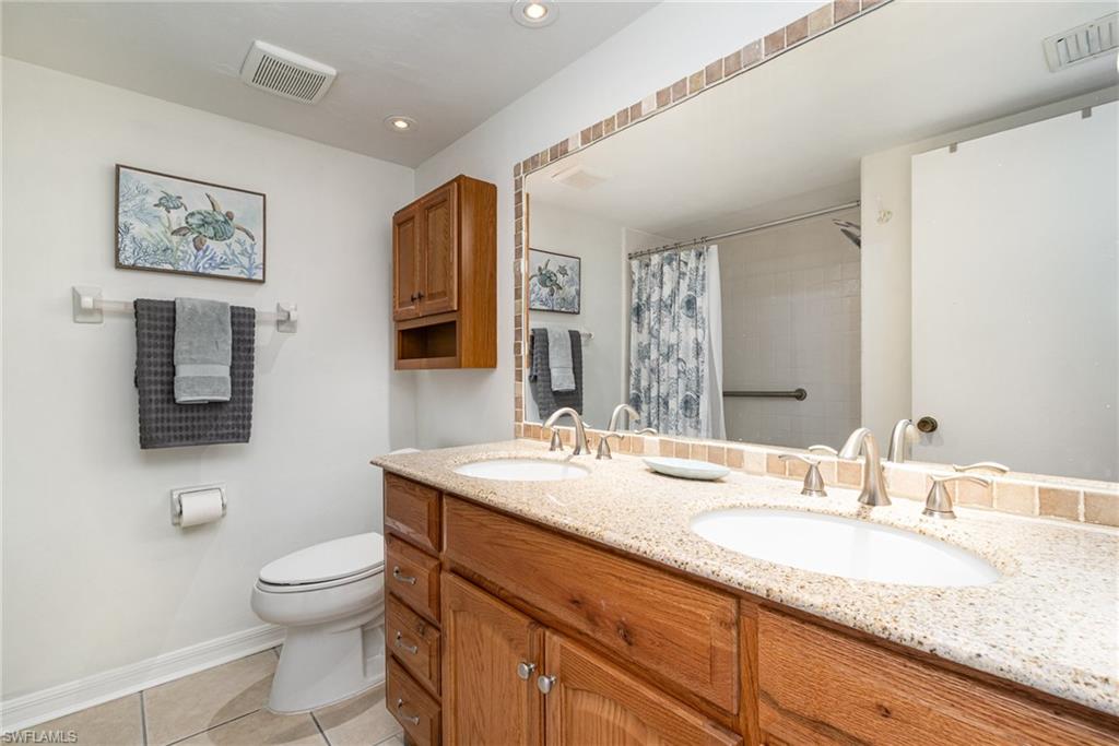 5535 Rattlesnake Hammock Road, Unit 103 Naples, FL 34113 - Photo 15 of 25 Guest Bathroom with double vanity, updated toilet and tub/shower combo.