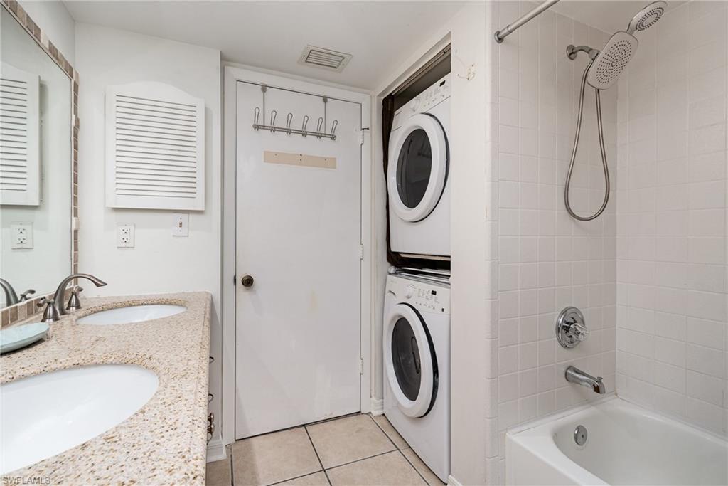 5535 Rattlesnake Hammock Road, Unit 103 Naples, FL 34113 - Photo 17 of 25 Guest Bathroom also features stacked washer/dryer.