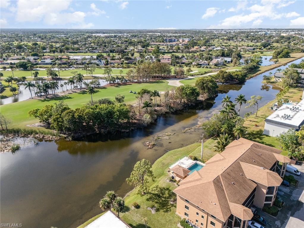 5535 Rattlesnake Hammock Road, Unit 103 Naples, FL 34113 - Photo 22 of 25 Aerial view featuring a water view
