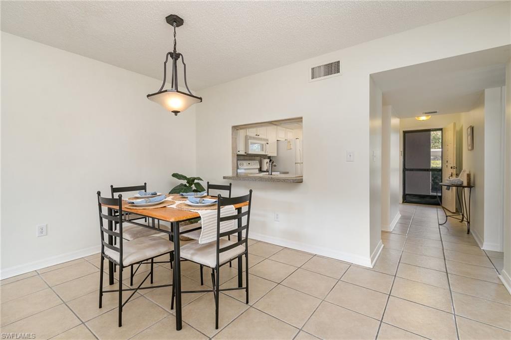 5535 Rattlesnake Hammock Road, Unit 103 Naples, FL 34113 - Photo 6 of 25 Dining area looking back towards kitchen and entryway.