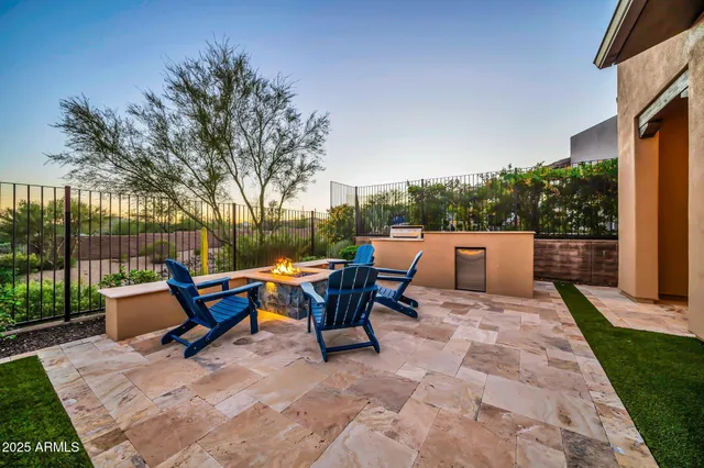 a backyard of a house with table and chairs