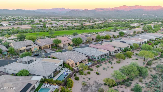 a view of a swimming pool with lawn chairs and couches