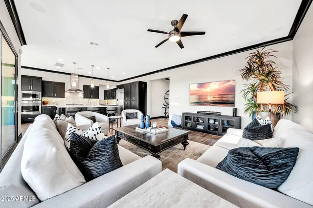 a dining hall with stainless steel appliances granite countertop a dining table and chairs