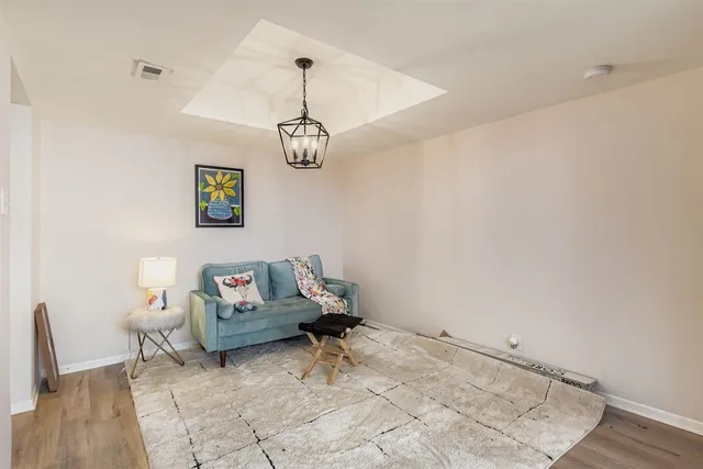 a living room with furniture and a chandelier