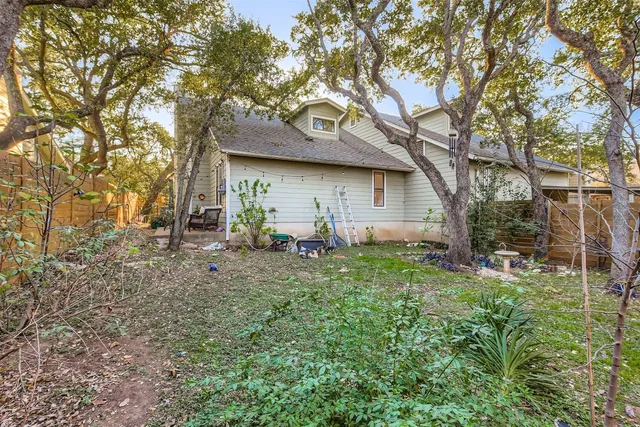 a backyard of a house with table and chairs