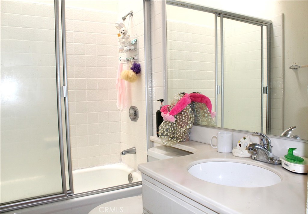 21 Wellesley, Unit 24 Irvine, CA 92612 - Photo 22 of 31 a bathroom with a granite countertop sink and a mirror