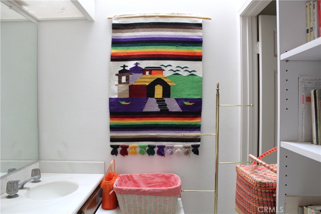 21 Wellesley, Unit 24 Irvine, CA 92612 - Photo 25 of 31 a bathroom with a sink and a mirror