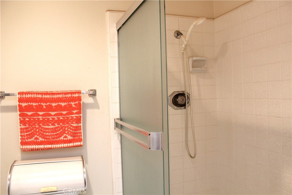 21 Wellesley, Unit 24 Irvine, CA 92612 - Photo 26 of 31 a bathroom with a shower and a window