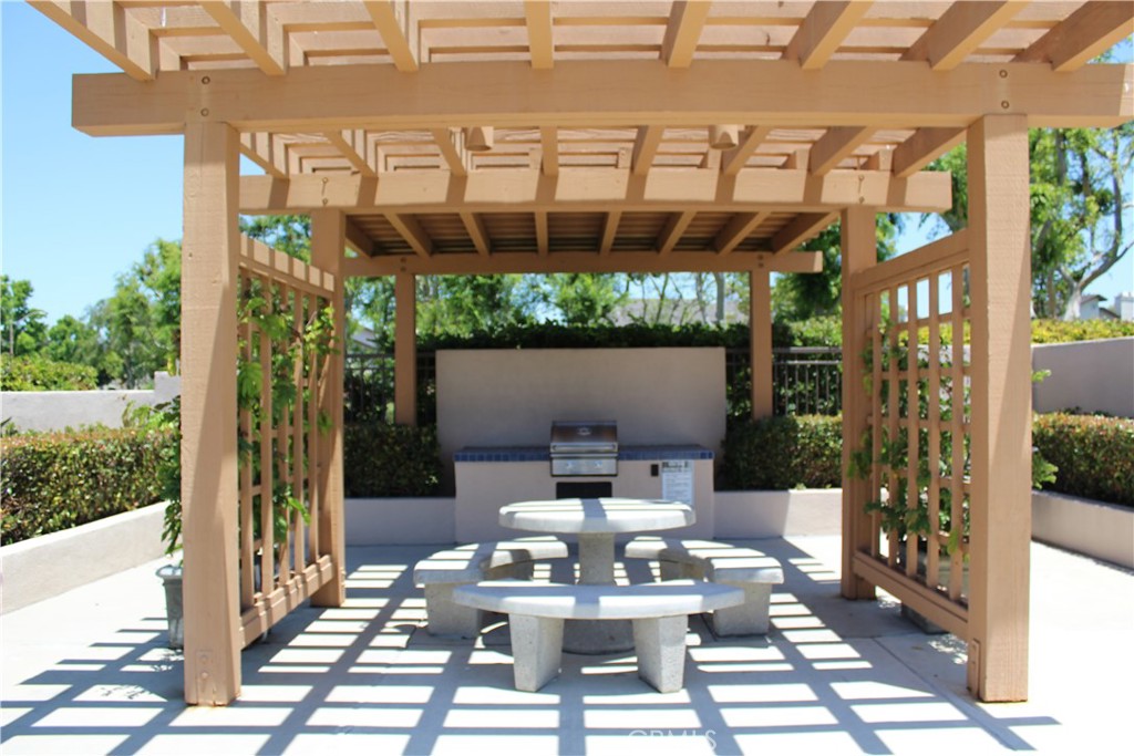 21 Wellesley, Unit 24 Irvine, CA 92612 - Photo 28 of 31 a view of a patio with table and chairs and potted plants