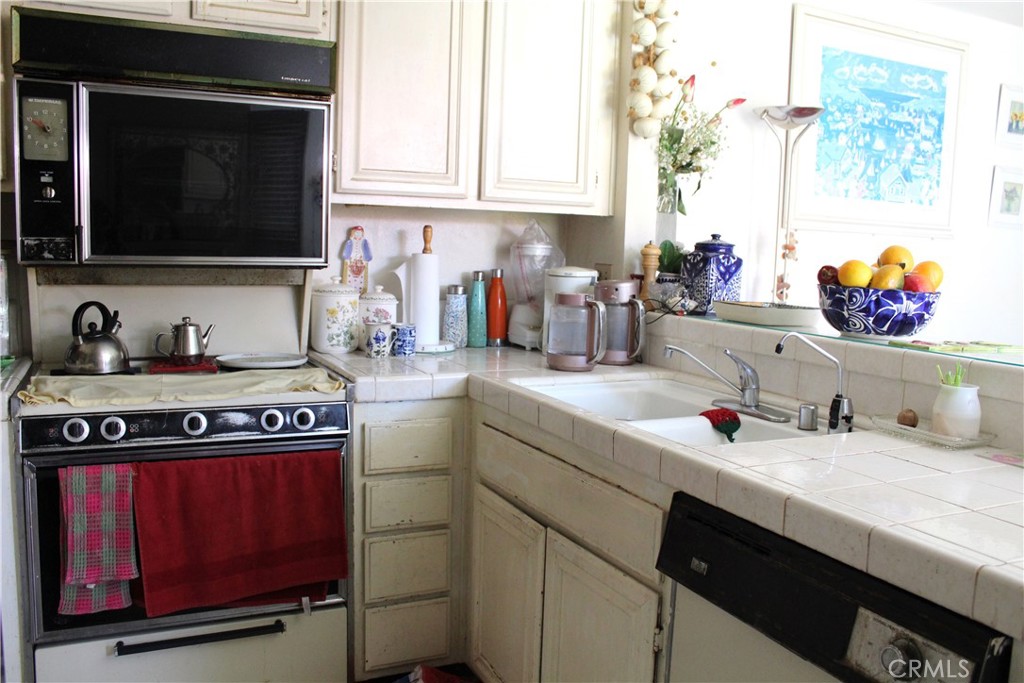 21 Wellesley, Unit 24 Irvine, CA 92612 - Photo 9 of 31 a kitchen with stainless steel appliances a sink stove and cabinets