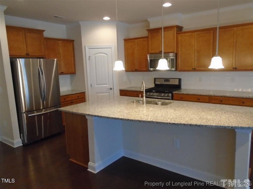 234 Daymire Glen Lane Cary, NC 27519 - Photo 5 of 8 a kitchen with stainless steel appliances granite countertop a sink a stove and a refrigerator