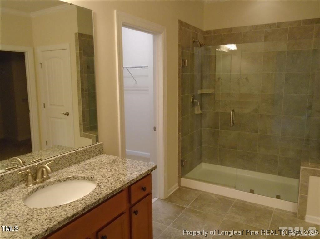 234 Daymire Glen Lane Cary, NC 27519 - Photo 7 of 8 a bathroom with a granite countertop sink a shower and a mirror