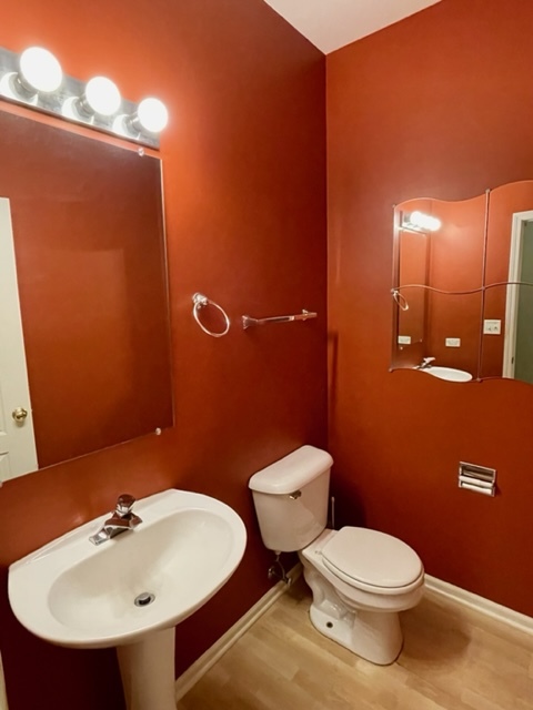2459 Oneida Lane Naperville, IL 60563 - Photo 4 of 14 a bathroom with a sink a toilet and mirror