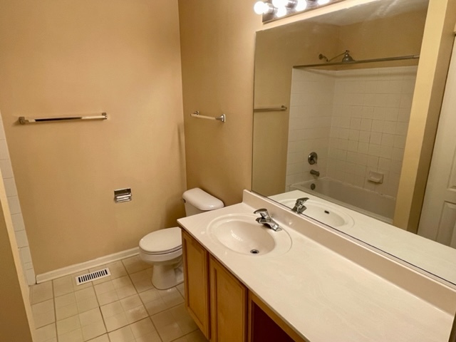 2459 Oneida Lane Naperville, IL 60563 - Photo 10 of 14 a bathroom with a sink a toilet and a mirror
