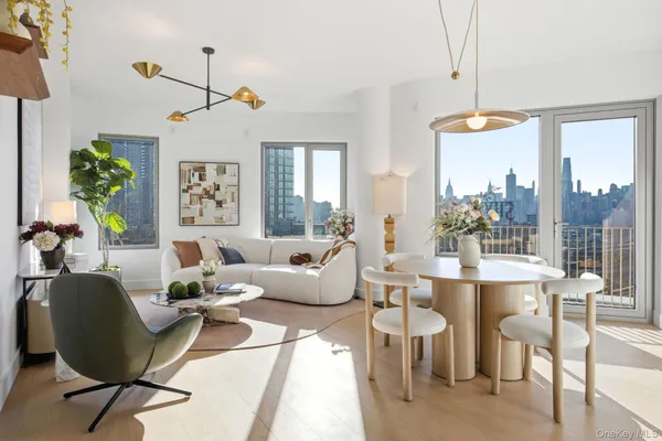 a living room with furniture a chandelier and a window
