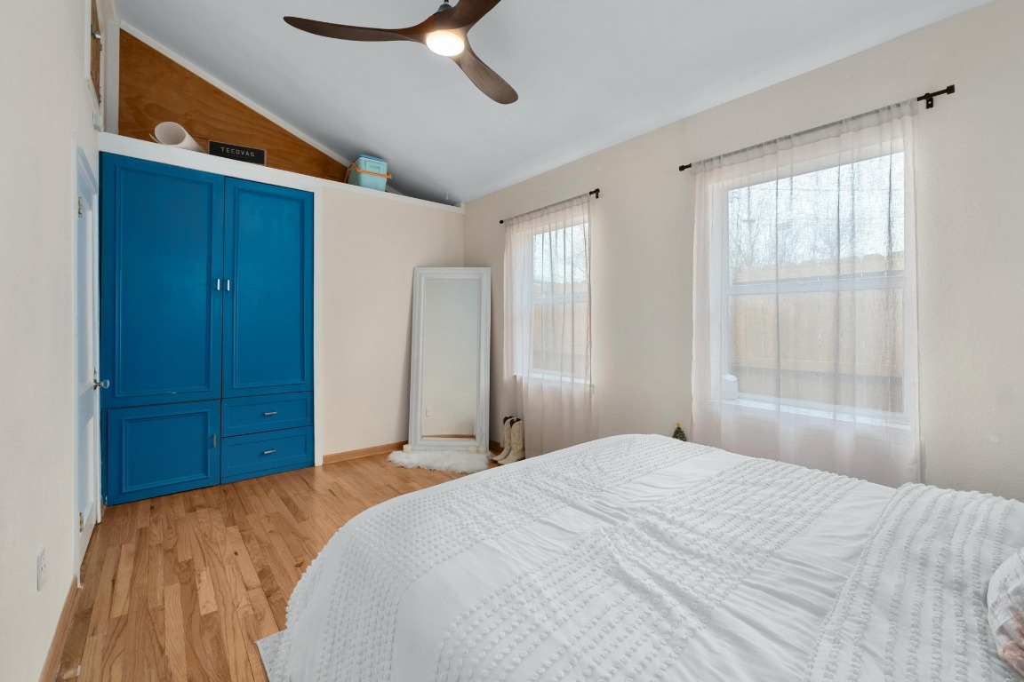 4610 Avenue B, Unit B Austin, TX 78751 - Photo 12 of 22 Bedroom featuring light wood finished floors, lofted ceiling, and a ceiling fan