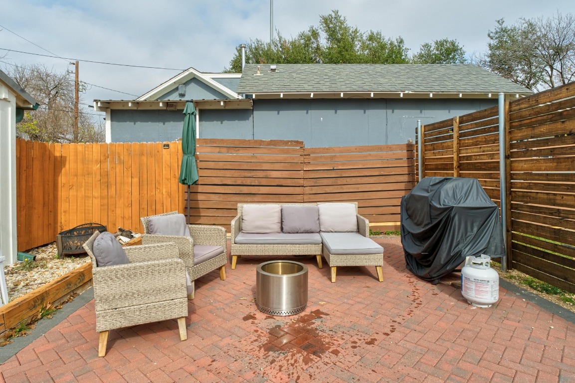 4610 Avenue B, Unit B Austin, TX 78751 - Photo 16 of 22 Fenced backyard featuring area for grilling, a patio area, and an outdoor living space
