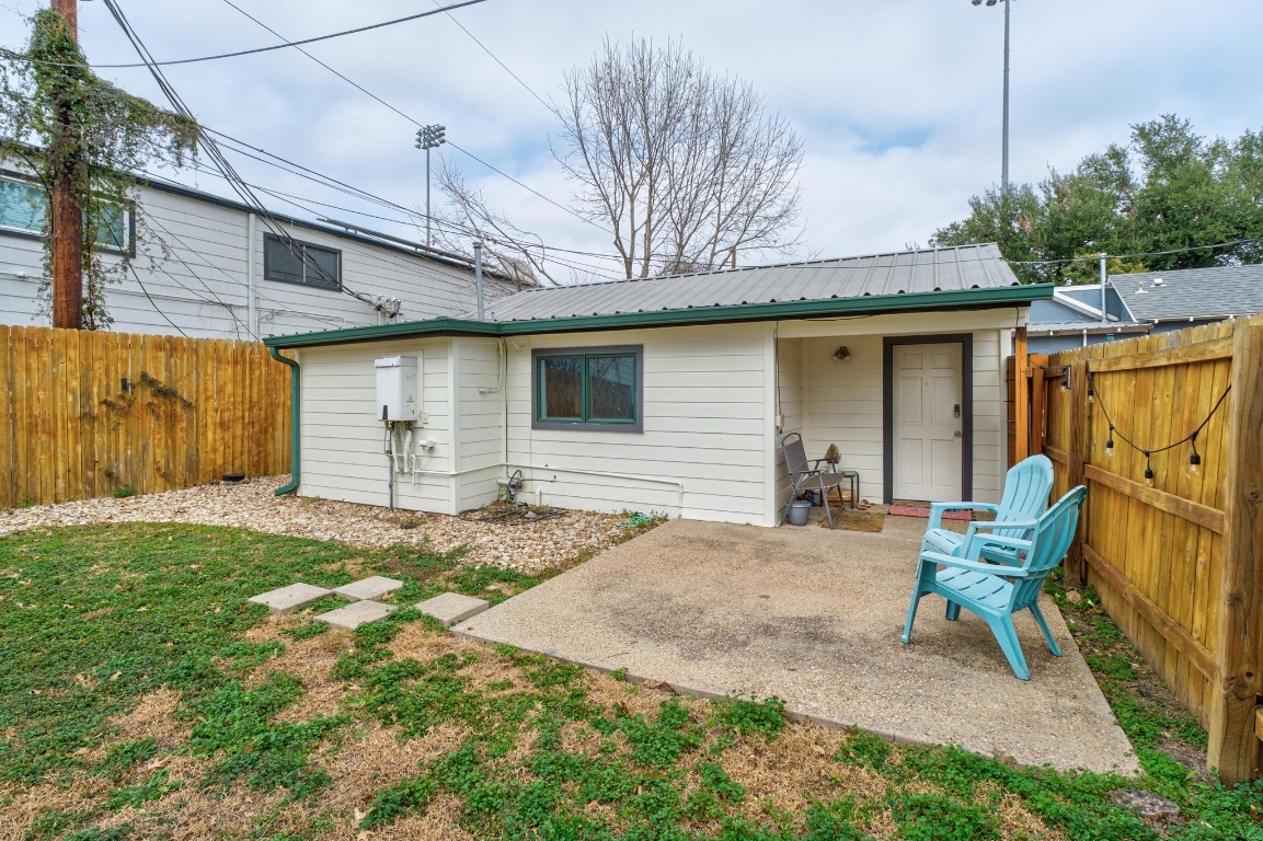 4610 Avenue B, Unit B Austin, TX 78751 - Photo 17 of 22 Back of house with a fenced backyard, a patio, and a metal roof