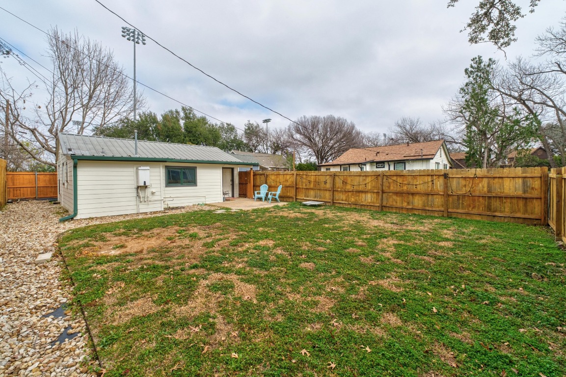 4610 Avenue B, Unit B Austin, TX 78751 - Photo 20 of 22 Rear view of house featuring a patio area, a fenced backyard, and a metal roof