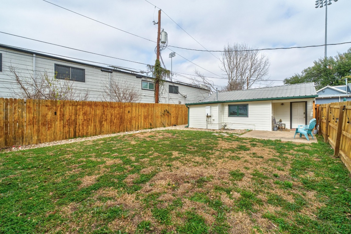 4610 Avenue B, Unit B Austin, TX 78751 - Photo 21 of 22 Back of house with a fenced backyard, a patio area, and a metal roof