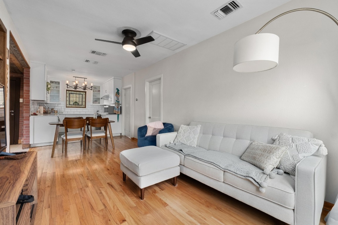 4610 Avenue B, Unit B Austin, TX 78751 - Photo 4 of 22 Living room with light wood finished floors, a chandelier, and a ceiling fan