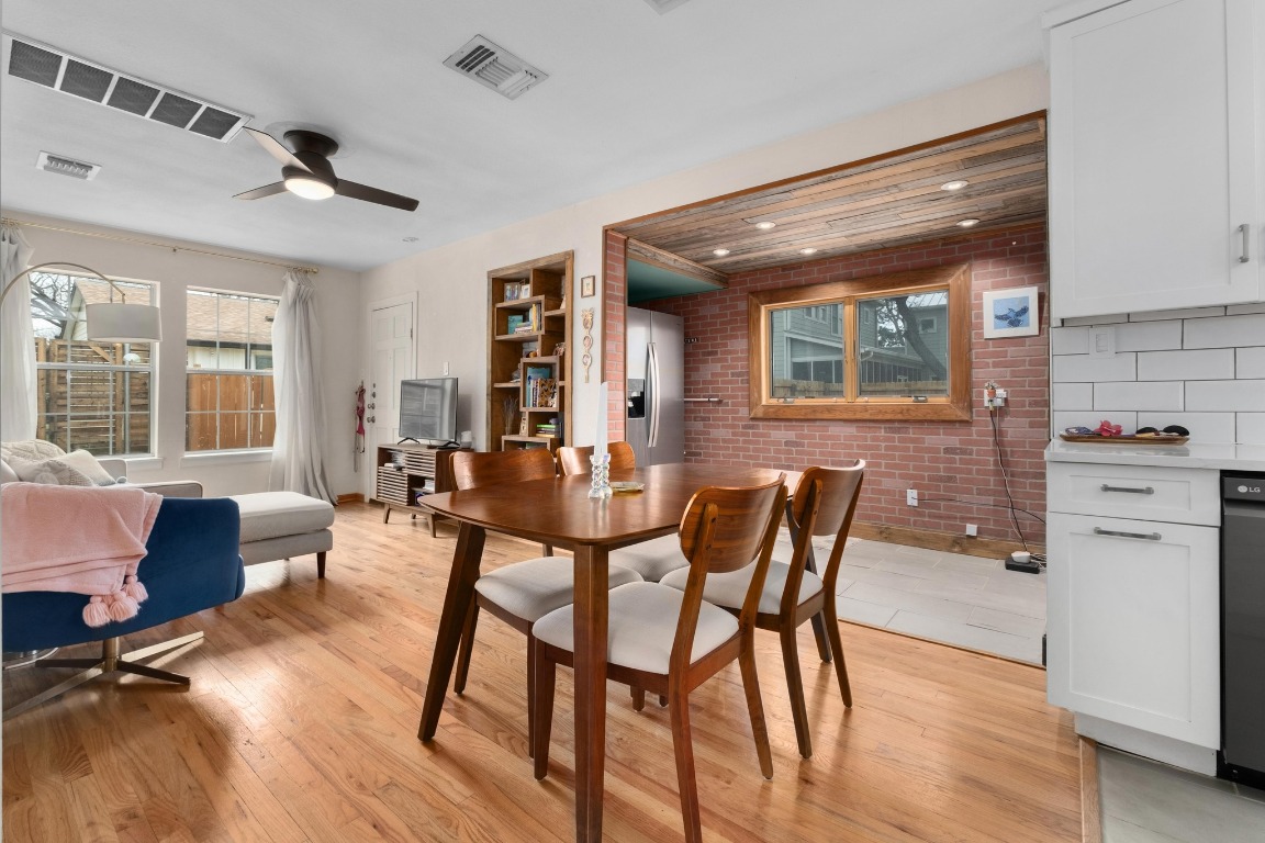 4610 Avenue B, Unit B Austin, TX 78751 - Photo 7 of 22 Dining area featuring light wood-style flooring, brick wall, and ceiling fan