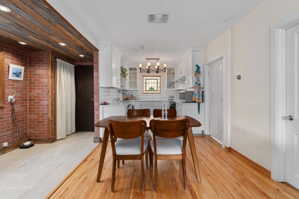 4610 Avenue B, Unit B Austin, TX 78751 - Photo 8 of 22 Dining area with light wood finished floors and a chandelier