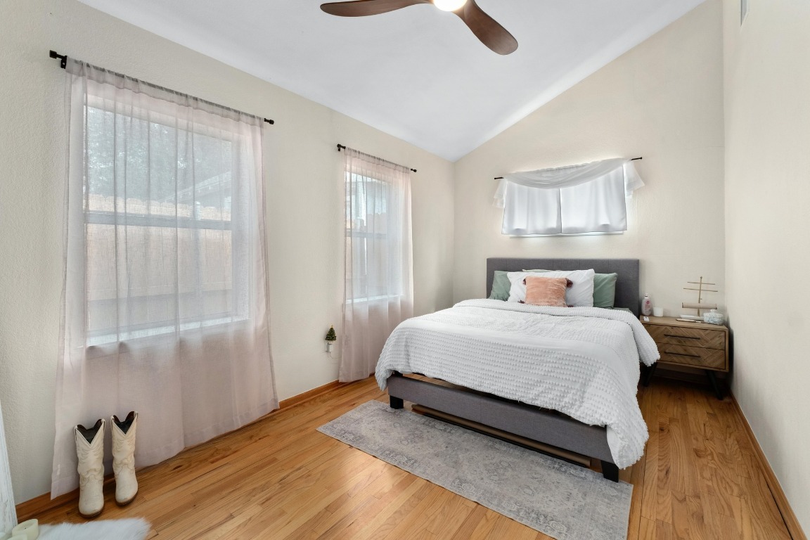 4610 Avenue B, Unit B Austin, TX 78751 - Photo 10 of 22 Bedroom featuring vaulted ceiling, wood finished floors, and ceiling fan