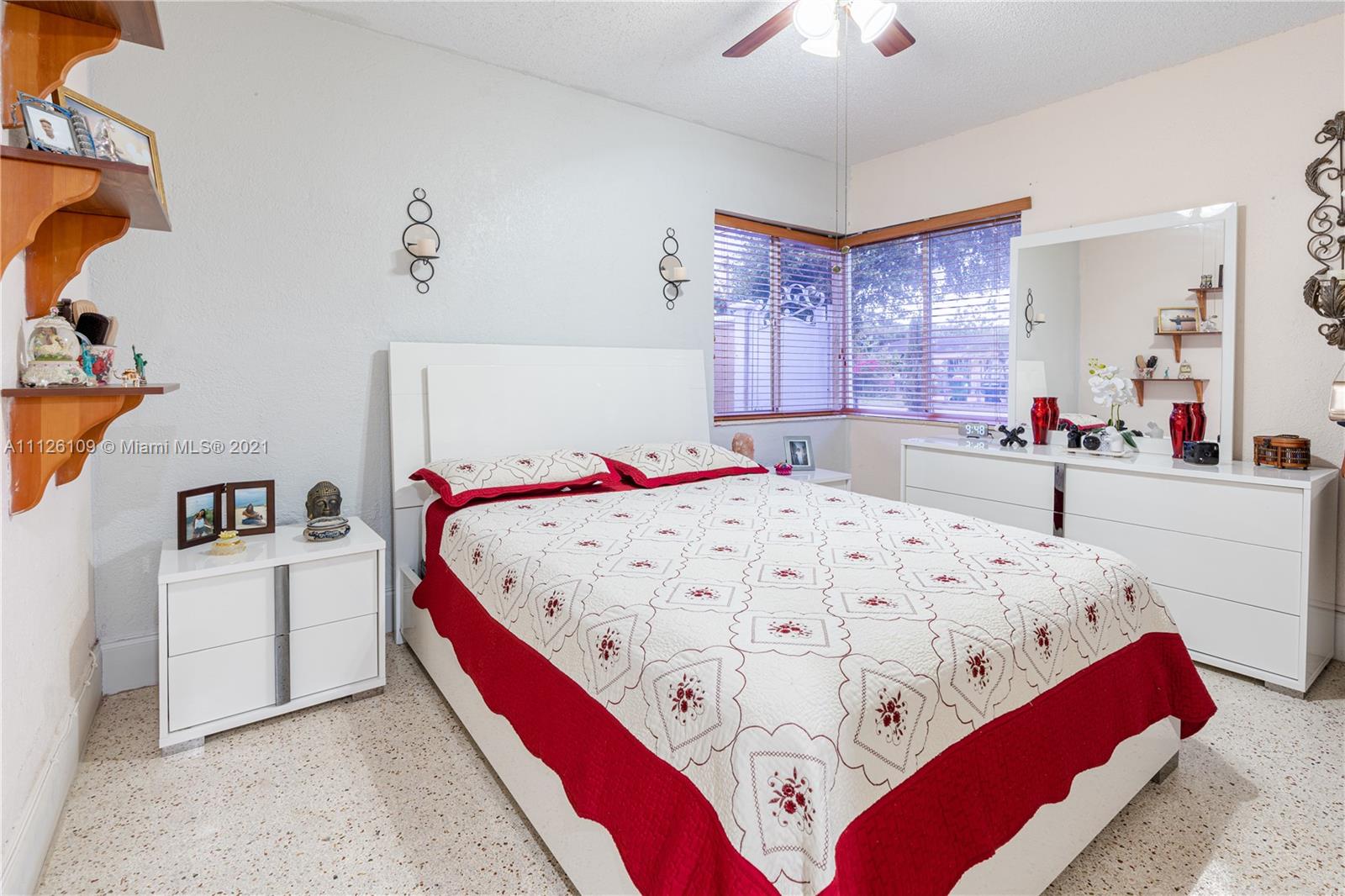 6181 Southwest 20th Street West Miami, FL 33155 - Photo 14 of 31 a bedroom with a bed and a chandelier