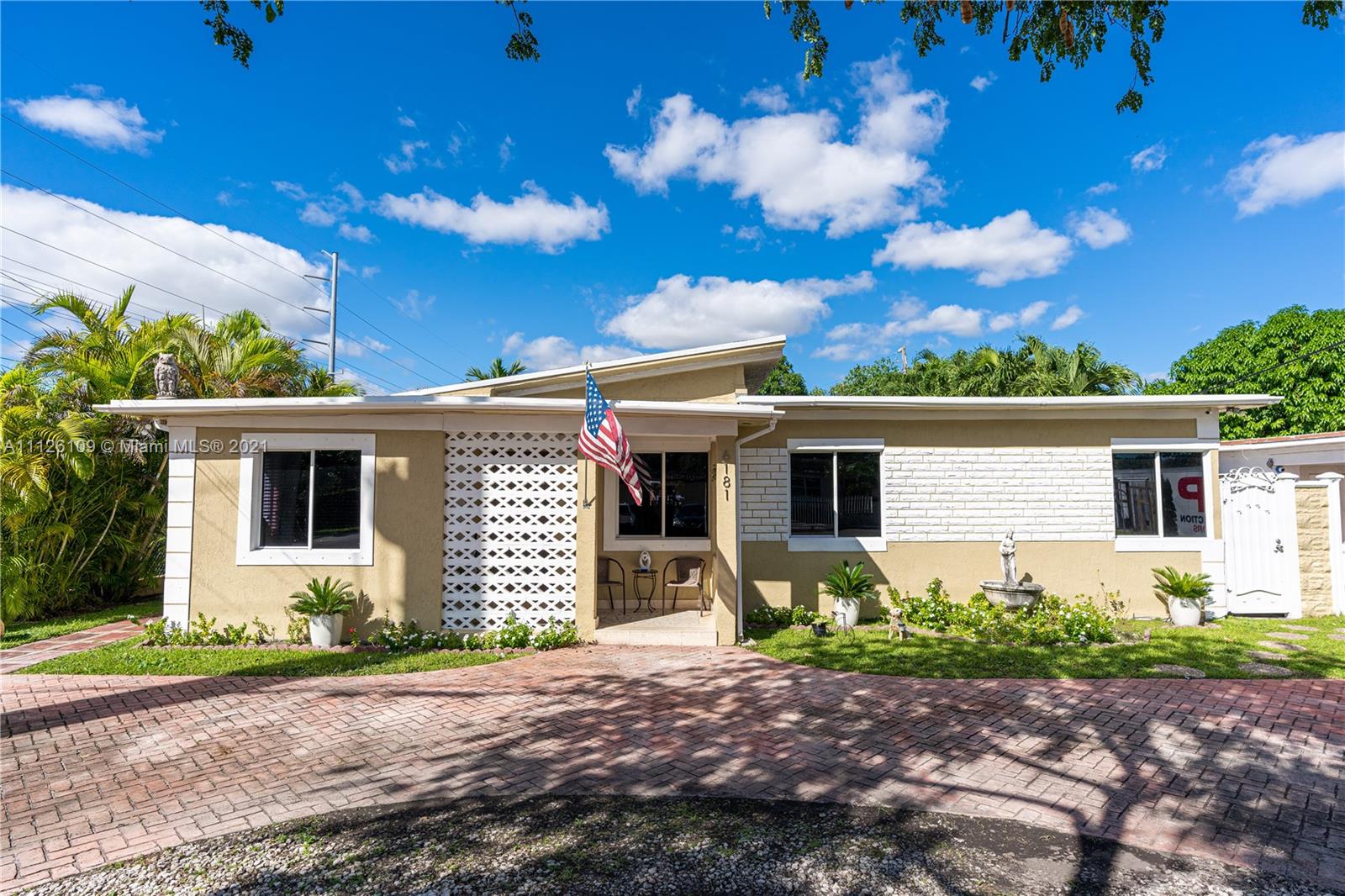6181 Southwest 20th Street West Miami, FL 33155 - Photo 28 of 31 a front view of a house with a yard and garage