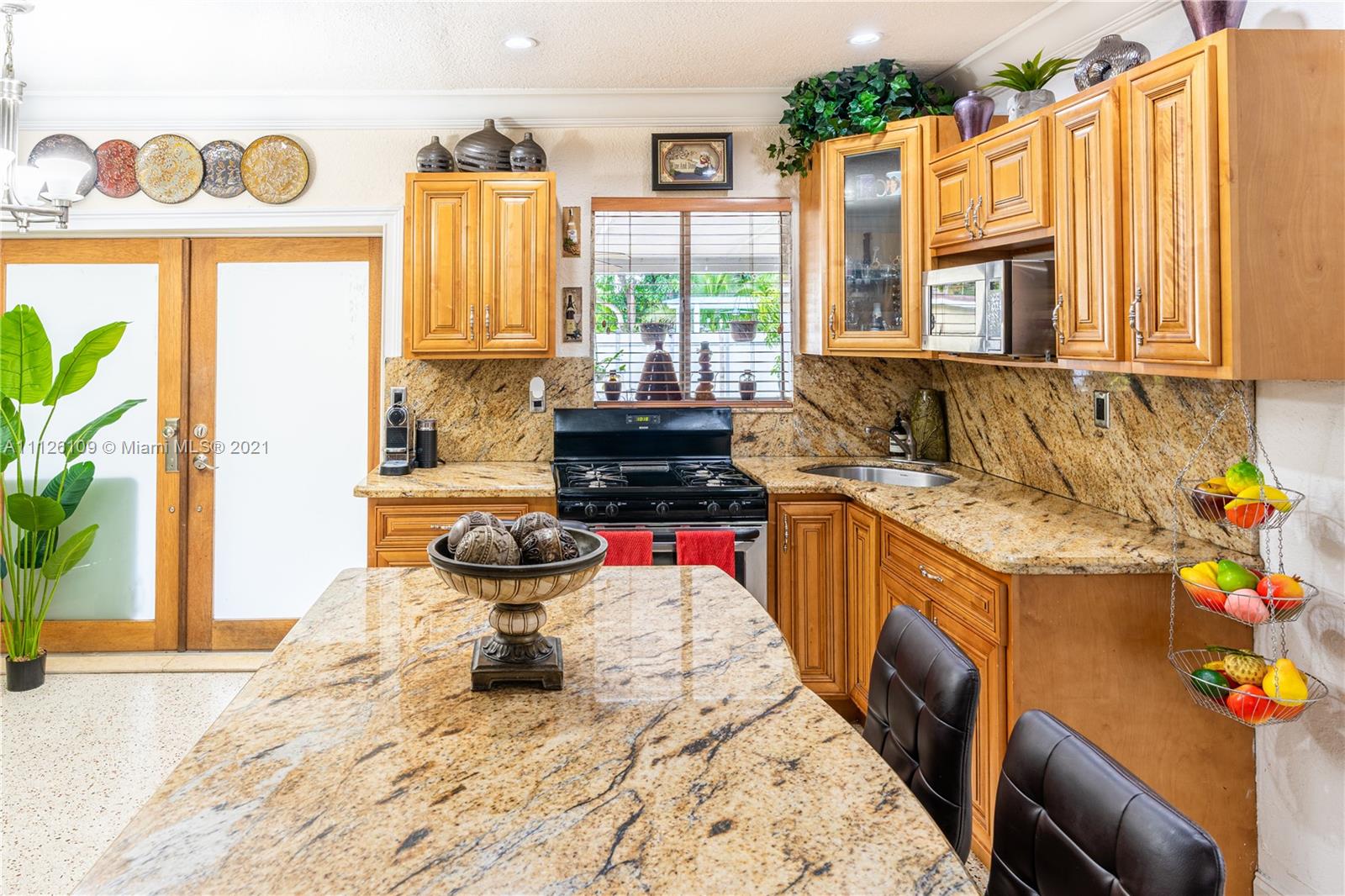 6181 Southwest 20th Street West Miami, FL 33155 - Photo 4 of 31 a kitchen with a sink and a stove