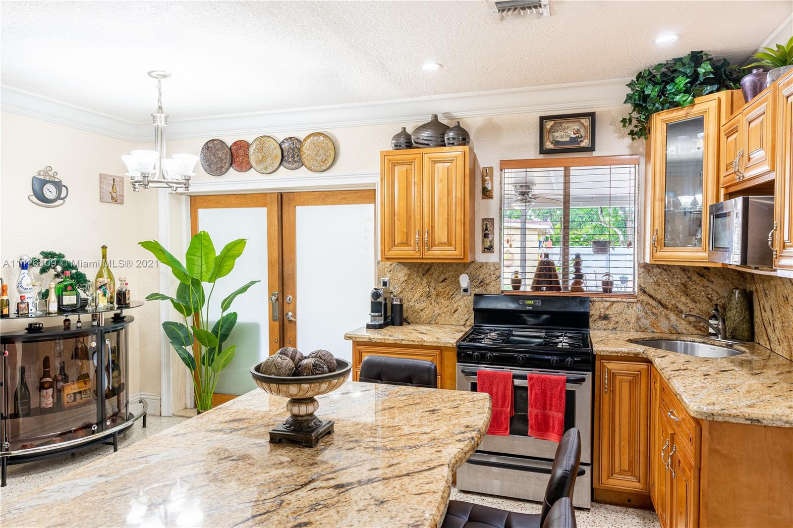 6181 Southwest 20th Street West Miami, FL 33155 - Photo 7 of 31 a kitchen with a stove a sink and a potted plant