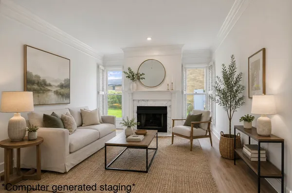 a view of an empty room with a fireplace and a window