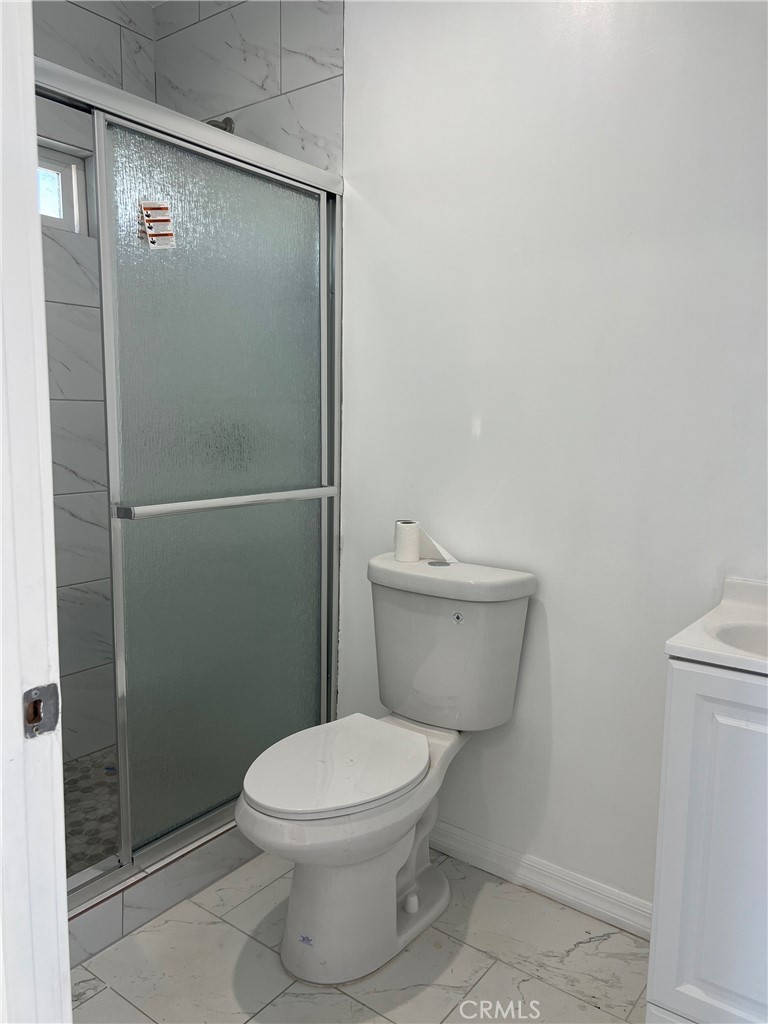 18740 Valerio Street Reseda, CA 91335 - Photo 5 of 5 a white toilet sitting next to a shower