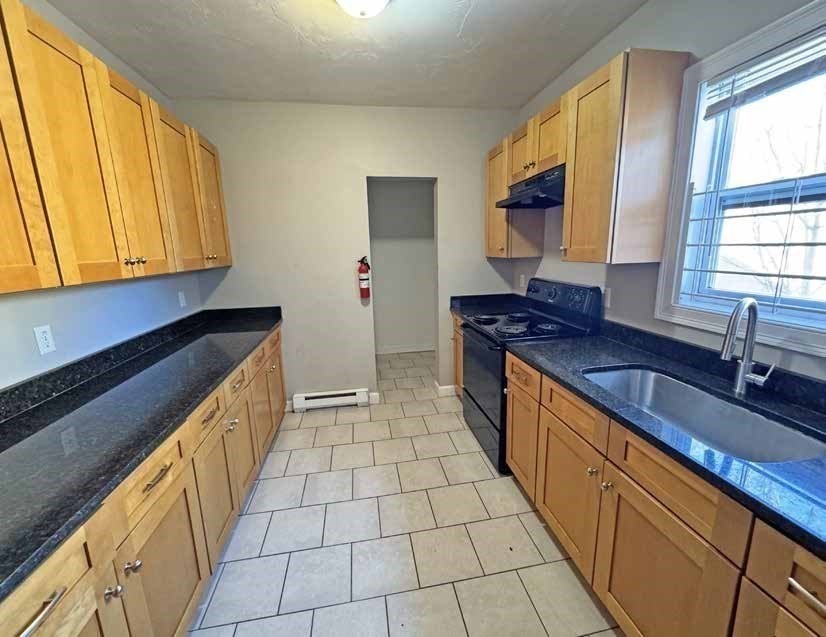 190 Washington Street Lynn, MA 01902 - Photo 11 of 19 a kitchen with stainless steel appliances a sink stove and cabinets