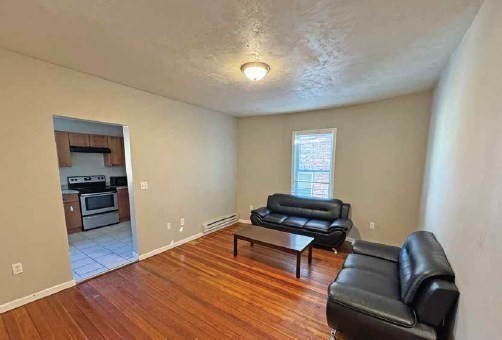 190 Washington Street Lynn, MA 01902 - Photo 12 of 19 a living room with furniture and a wooden floor