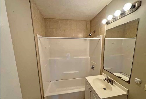 190 Washington Street Lynn, MA 01902 - Photo 17 of 19 a bathroom with a sink a mirror and a shower