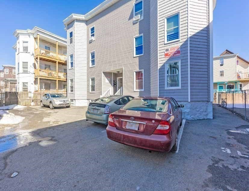 190 Washington Street Lynn, MA 01902 - Photo 6 of 19 a car parked in front of a brick house