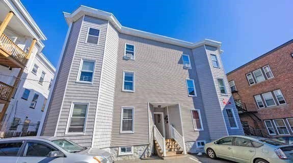 190 Washington Street Lynn, MA 01902 - Photo 9 of 19 a front view of a residential apartment building with a yard
